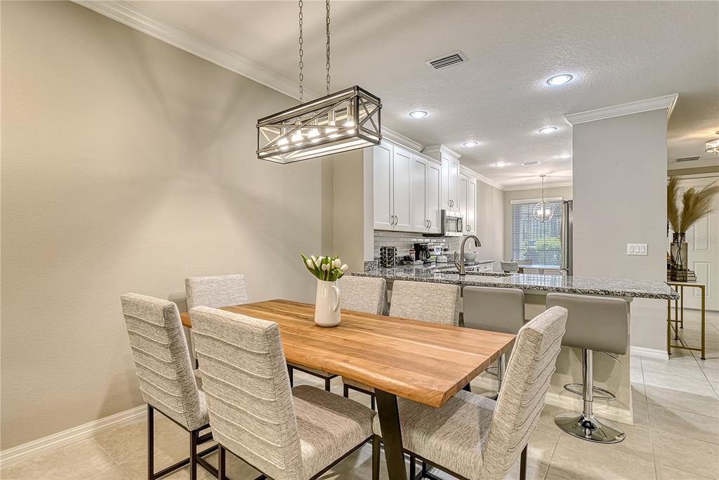 5420 Cicerone Street, Unit 101 Sarasota, FL 34238 - Photo 5 of 40 a dining room with a table or chairs and kitchen view