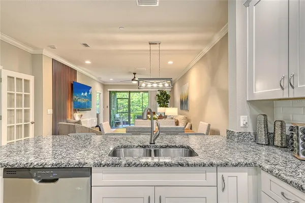 a kitchen with granite countertop a sink and a window