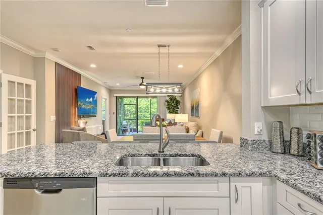 a kitchen with granite countertop a sink and a window