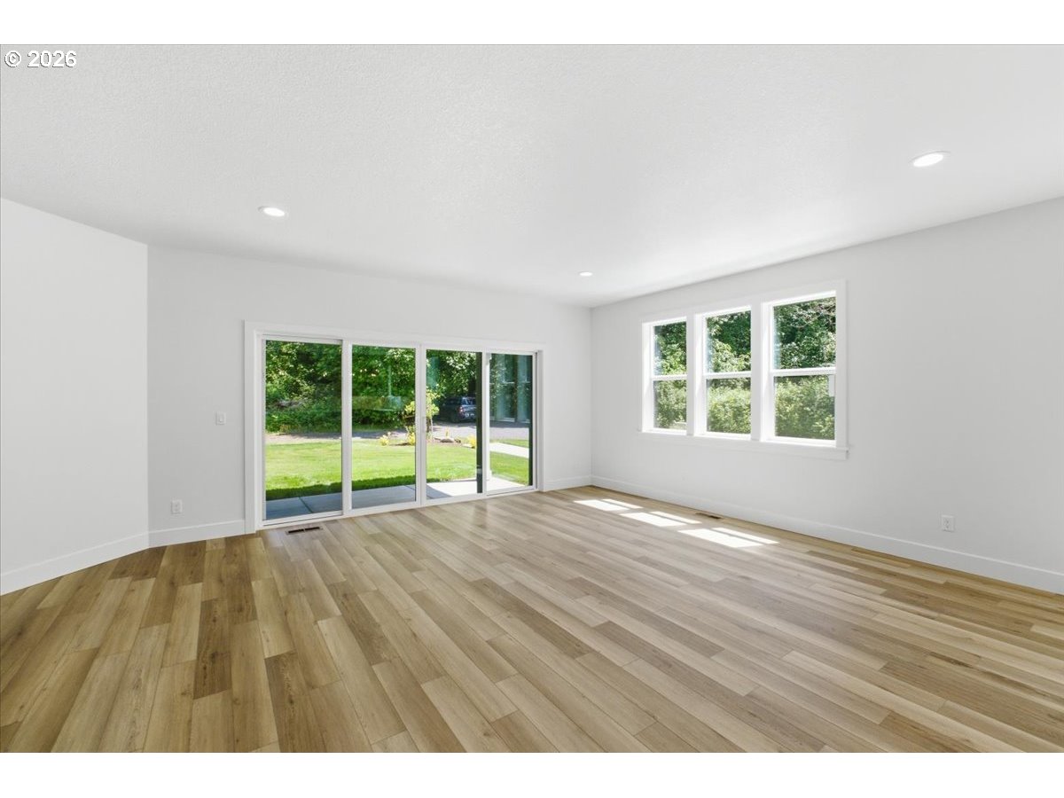 2147 Northeast Spitz Road Canby, OR 97013 - Photo 19 of 48 a view of an empty room with a window and wooden floor
