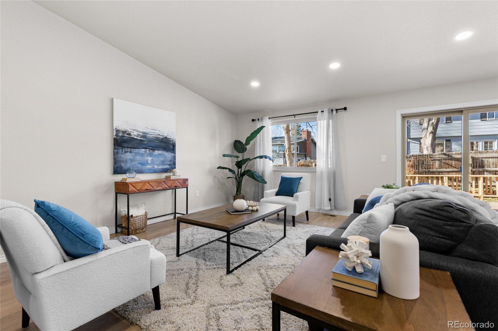 8205 Dudley Way Arvada, CO 80005 - Photo 11 of 44 a living room with furniture and a window