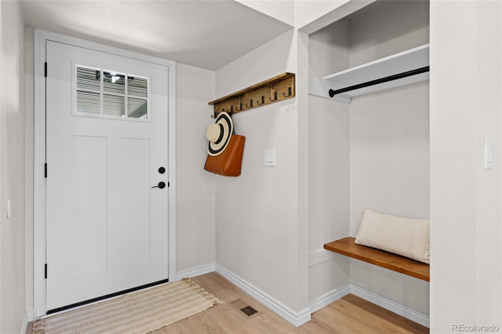 8205 Dudley Way Arvada, CO 80005 - Photo 13 of 44 a view of an entryway with wooden floor
