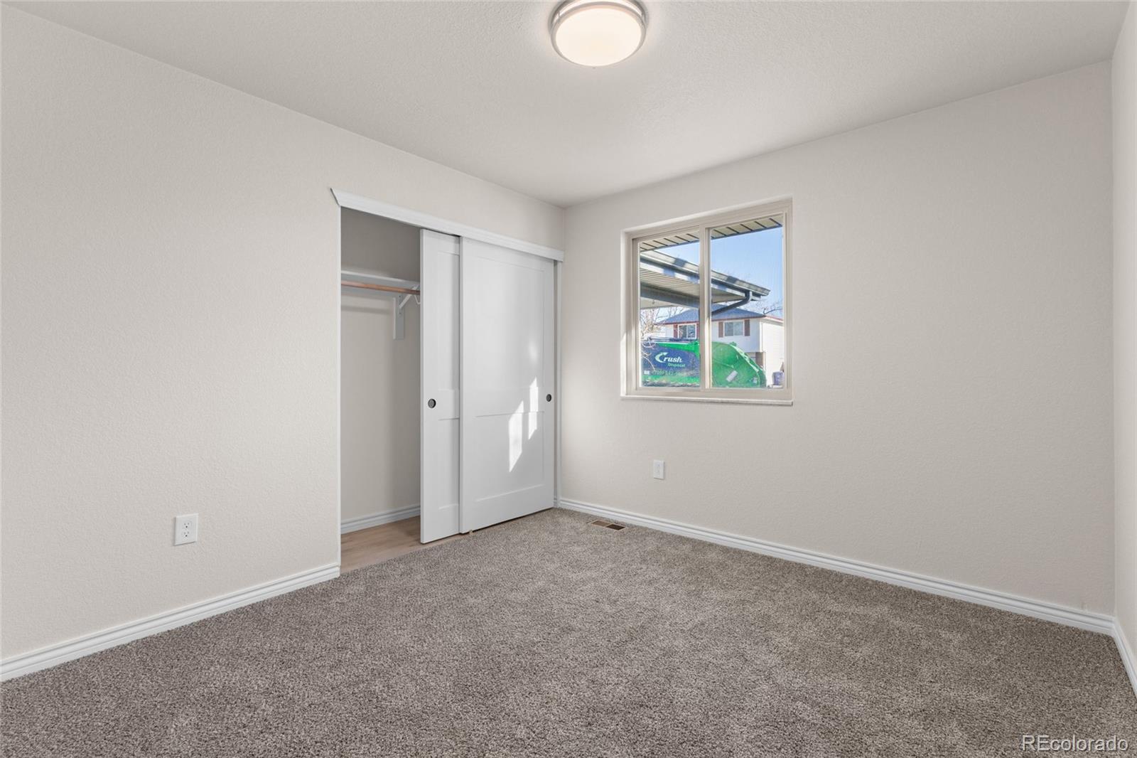 8205 Dudley Way Arvada, CO 80005 - Photo 19 of 44 an empty room with windows and closet