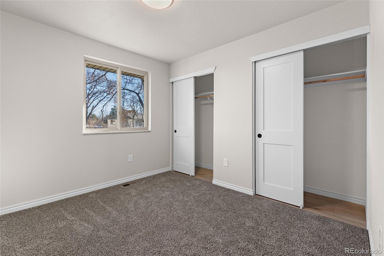 8205 Dudley Way Arvada, CO 80005 - Photo 20 of 44 an empty room with windows and closet