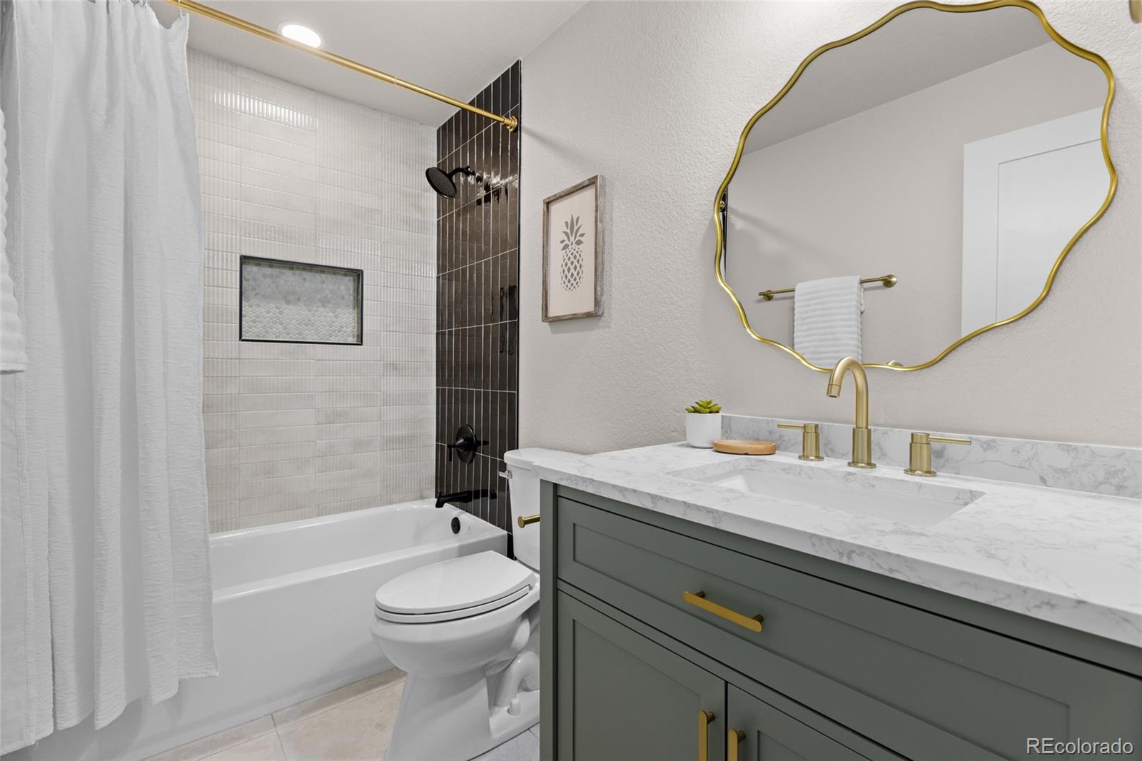 8205 Dudley Way Arvada, CO 80005 - Photo 21 of 44 a bathroom with a sink a toilet and shower