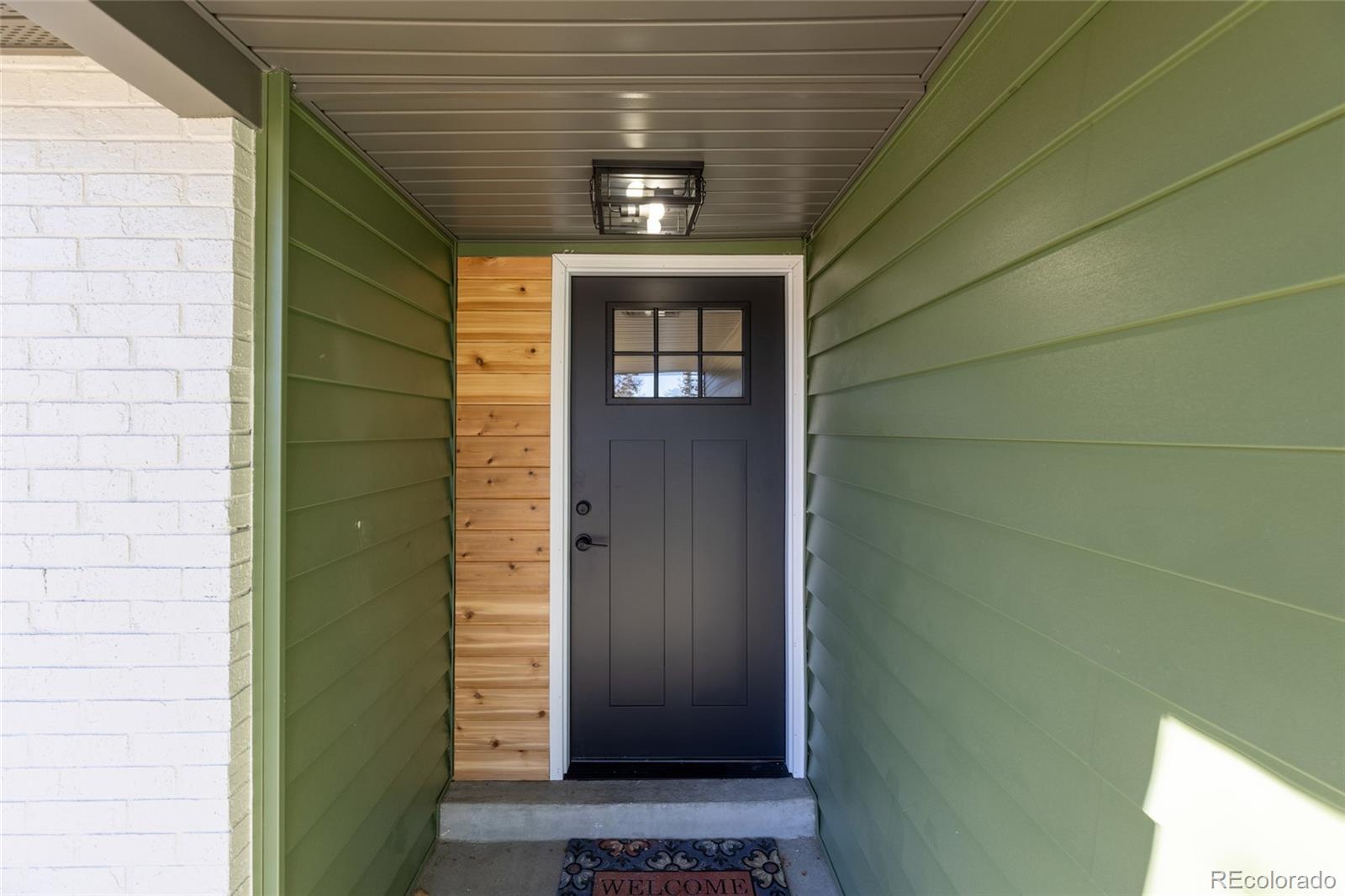 8205 Dudley Way Arvada, CO 80005 - Photo 3 of 44 a front view of a house