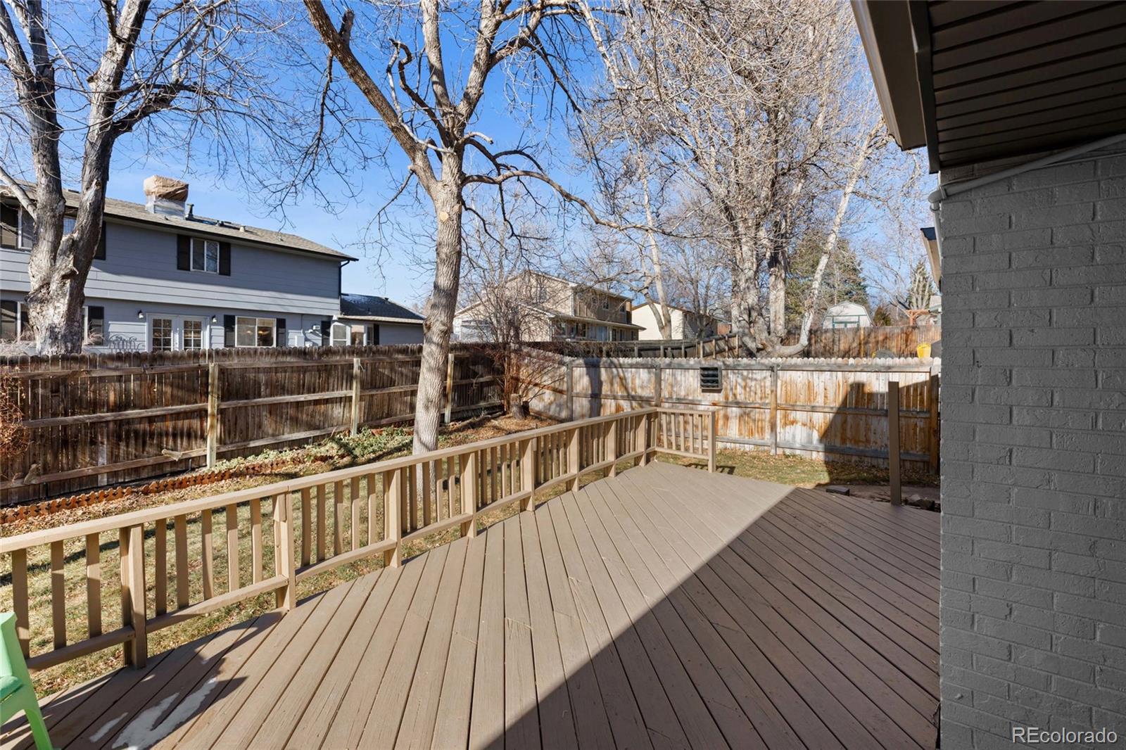 8205 Dudley Way Arvada, CO 80005 - Photo 31 of 44 a view of balcony with wooden floor and fence and a potted plant