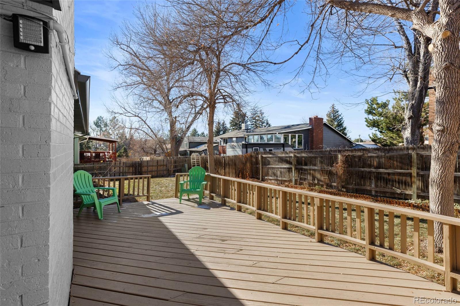 8205 Dudley Way Arvada, CO 80005 - Photo 32 of 44 a view of a balcony with two chairs and wooden floor