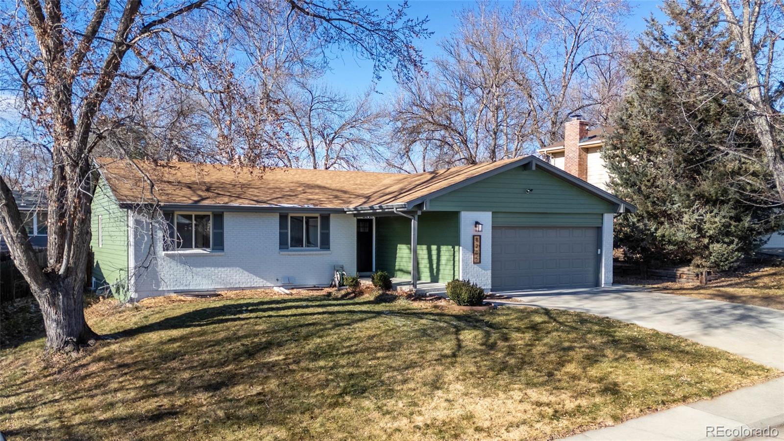 8205 Dudley Way Arvada, CO 80005 - Photo 34 of 44 a front view of house with yard and trees in the background