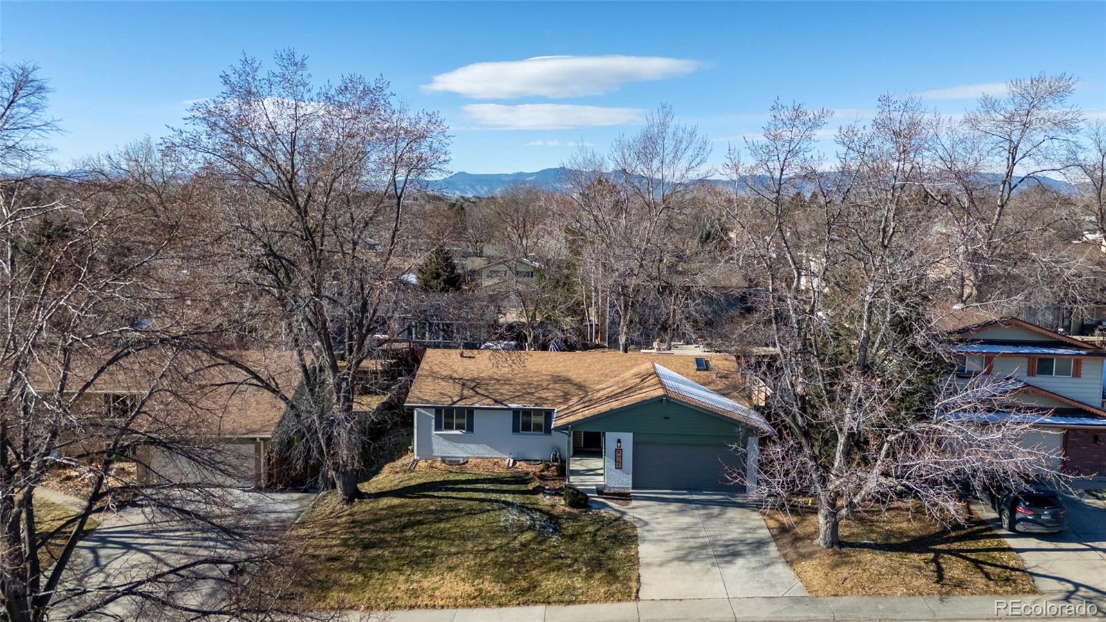 8205 Dudley Way Arvada, CO 80005 - Photo 36 of 44 a view of house with a yard and mountain view