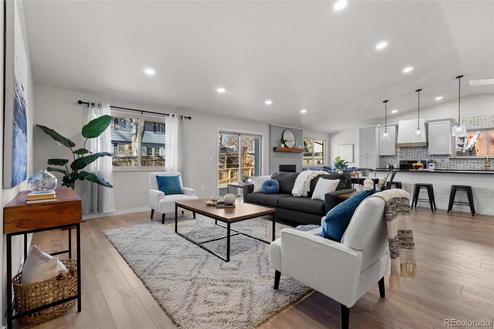 8205 Dudley Way Arvada, CO 80005 - Photo 4 of 44 a living room with furniture kitchen view and a piano
