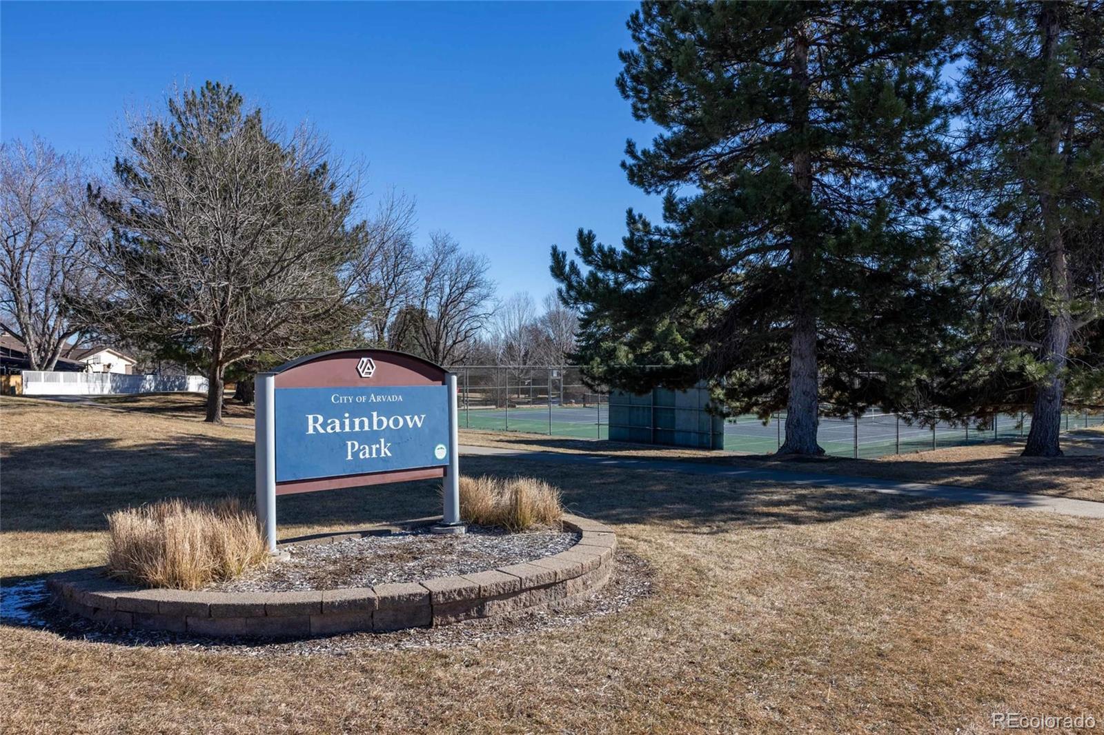 8205 Dudley Way Arvada, CO 80005 - Photo 42 of 44 a sign that is sitting on a road