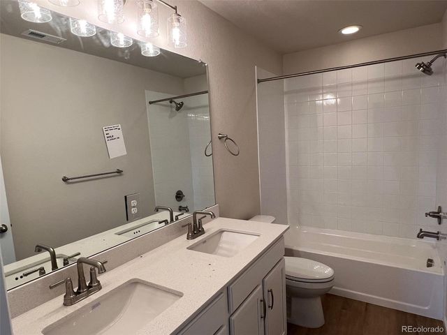 a bathroom with a sink toilet a mirror and shower