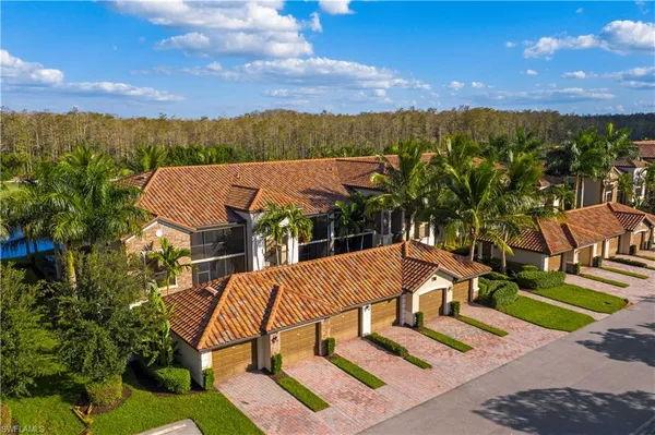 an aerial view of a house with a yard and lake view