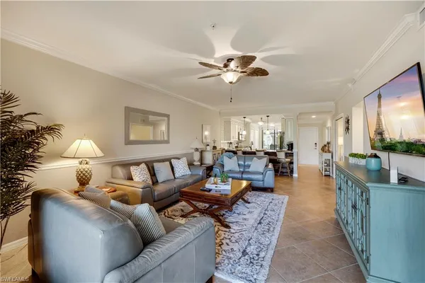 a living room with furniture and a chandelier