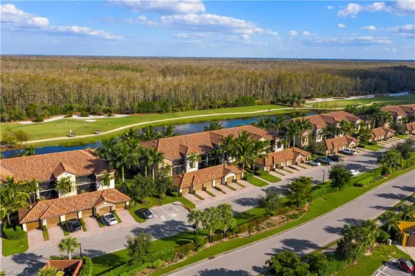 an aerial view of a city with lots of residential buildings and mountain view in back