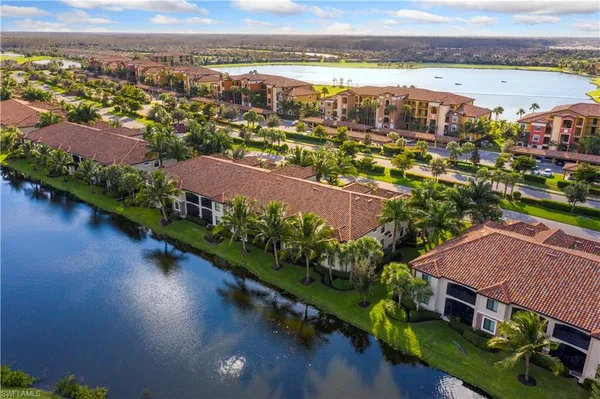 an aerial view of a house with a garden and lake view