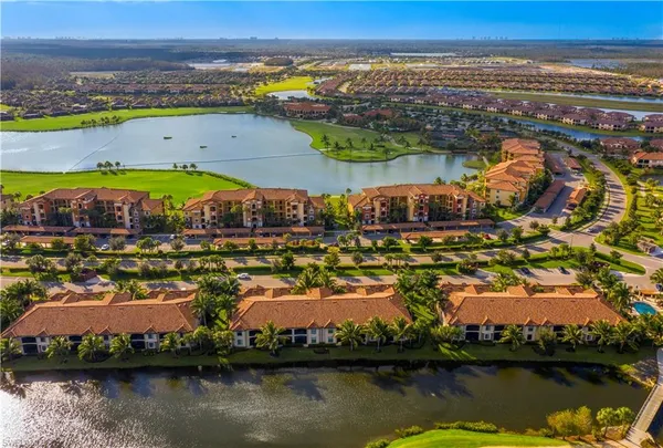 an aerial view of residential building and lake