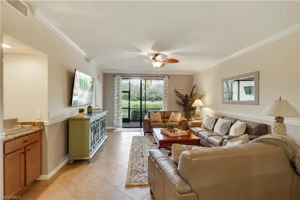a living room with furniture a large window with outer view