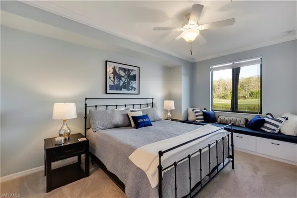 a bedroom with a bed a couch and a chandelier