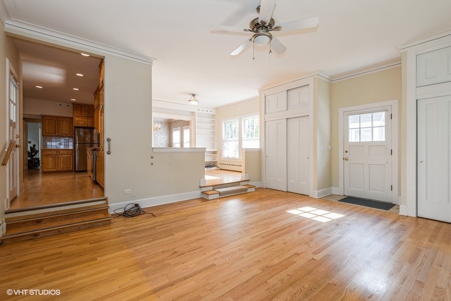 458 Sunset Road Winnetka, IL 60093 - Photo 8 of 17 a view of a livingroom with wooden floor and a ceiling fan