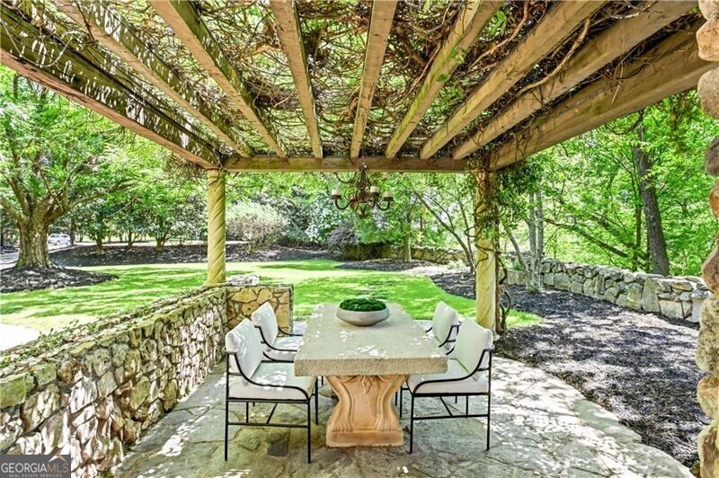 2100 West Wesley Road Northwest Atlanta, GA 30327 - Photo 33 of 42 a view of a table and chairs in the garden