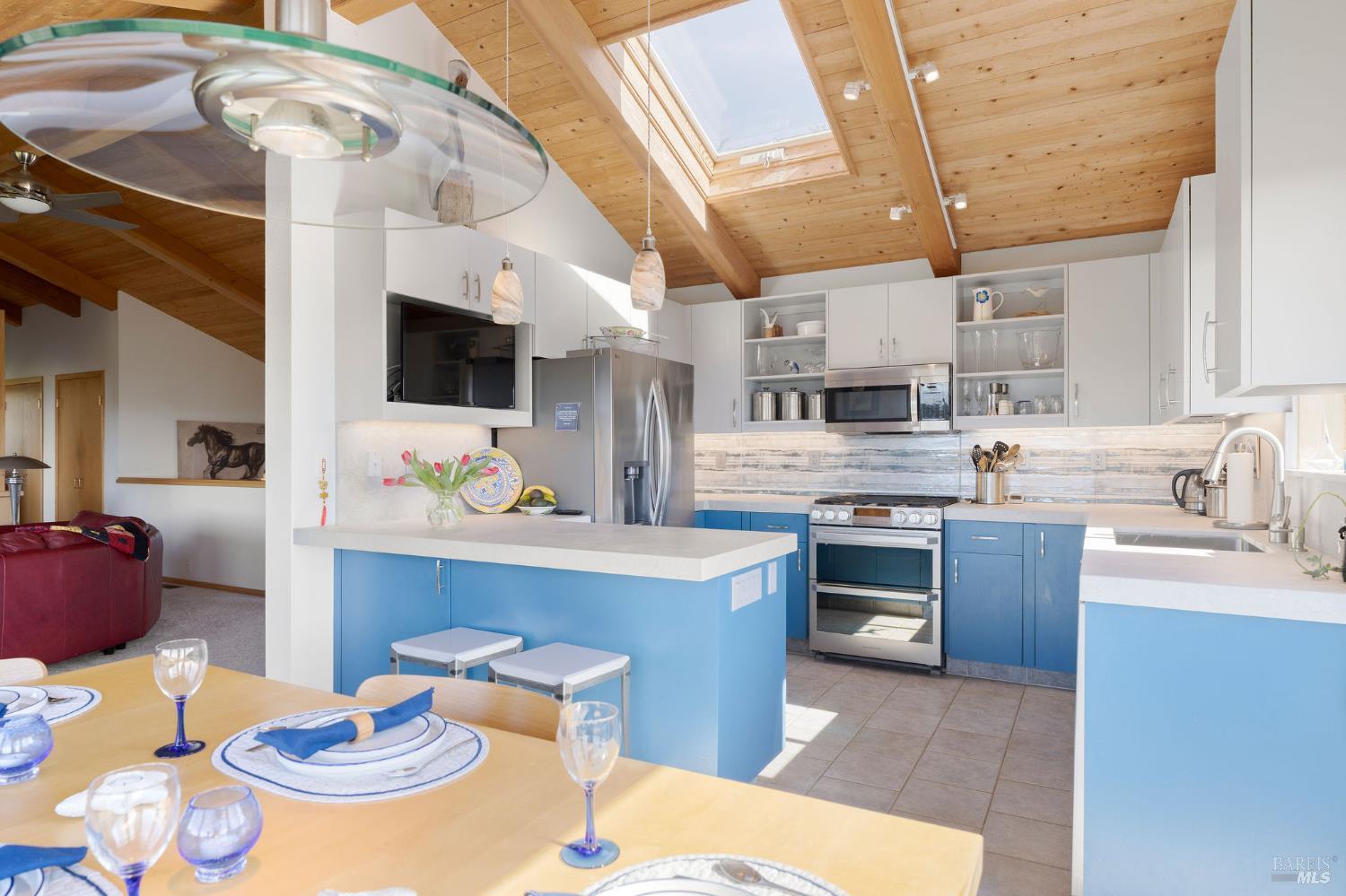39574 Leeward Road The Sea Ranch, CA 95497 - Photo 11 of 72 a kitchen with stainless steel appliances kitchen island granite countertop a sink and cabinets