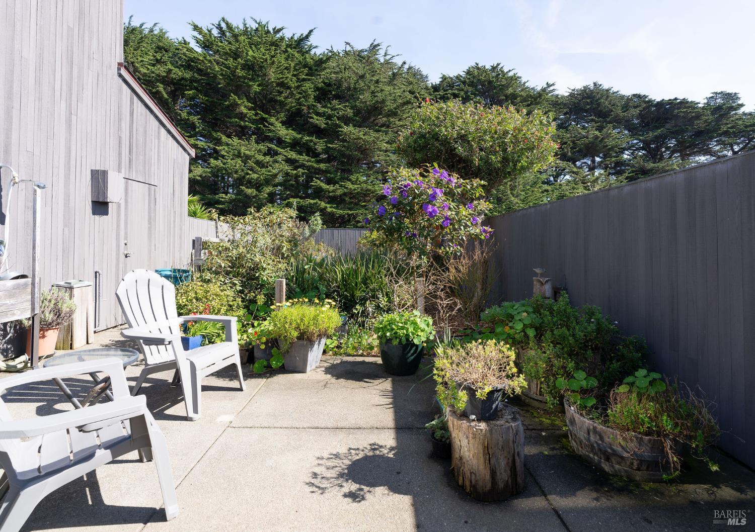 39574 Leeward Road The Sea Ranch, CA 95497 - Photo 44 of 72 a view of a patio with plants and chairs potted plants