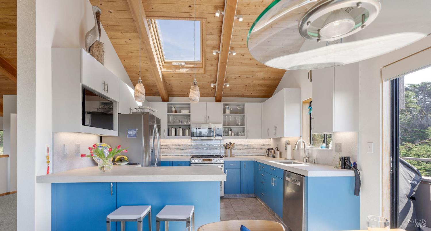 39574 Leeward Road The Sea Ranch, CA 95497 - Photo 5 of 72 a kitchen with stainless steel appliances granite countertop a sink a stove and a refrigerator