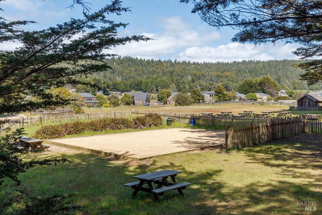 39574 Leeward Road The Sea Ranch, CA 95497 - Photo 65 of 72 a view of a lake with lawn chairs and large trees