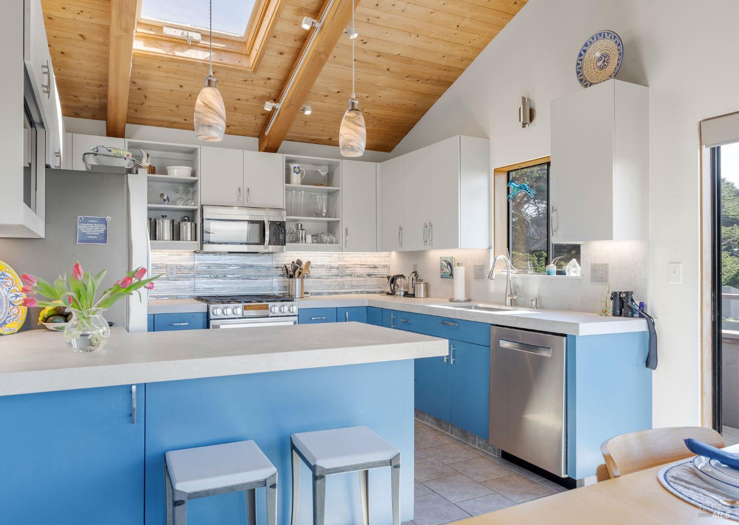 39574 Leeward Road The Sea Ranch, CA 95497 - Photo 9 of 72 a kitchen with cabinets a sink and chairs