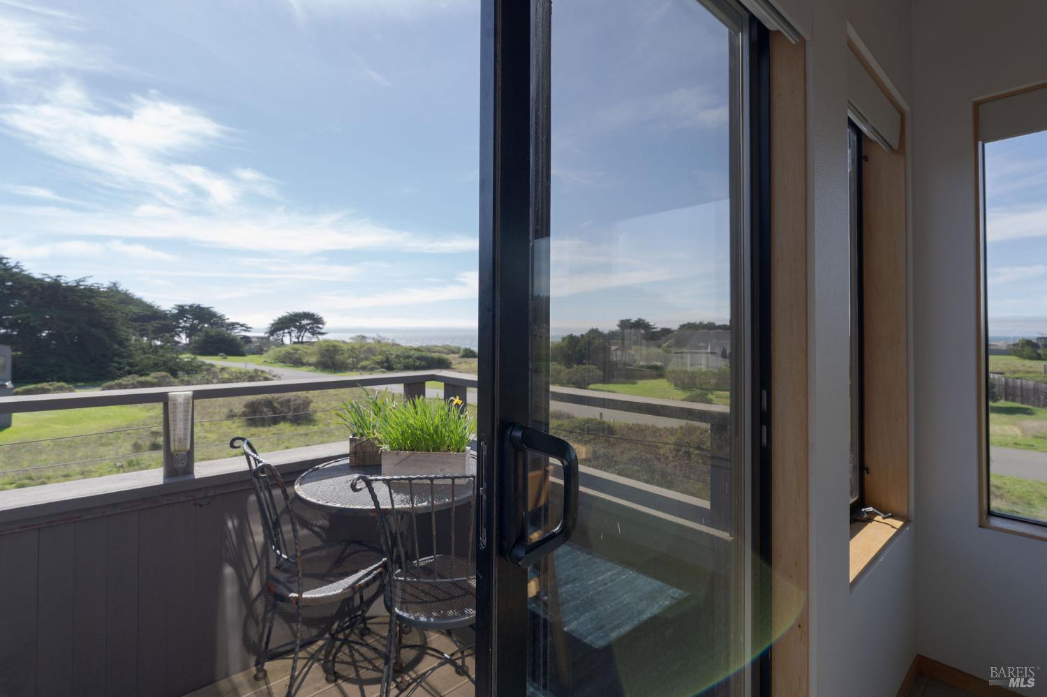 39574 Leeward Road The Sea Ranch, CA 95497 - Photo 10 of 72 a view of a lake from a balcony with seating space