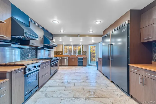 a large kitchen with stainless steel appliances kitchen island granite countertop a large counter top stainless steel appliances and cabinets