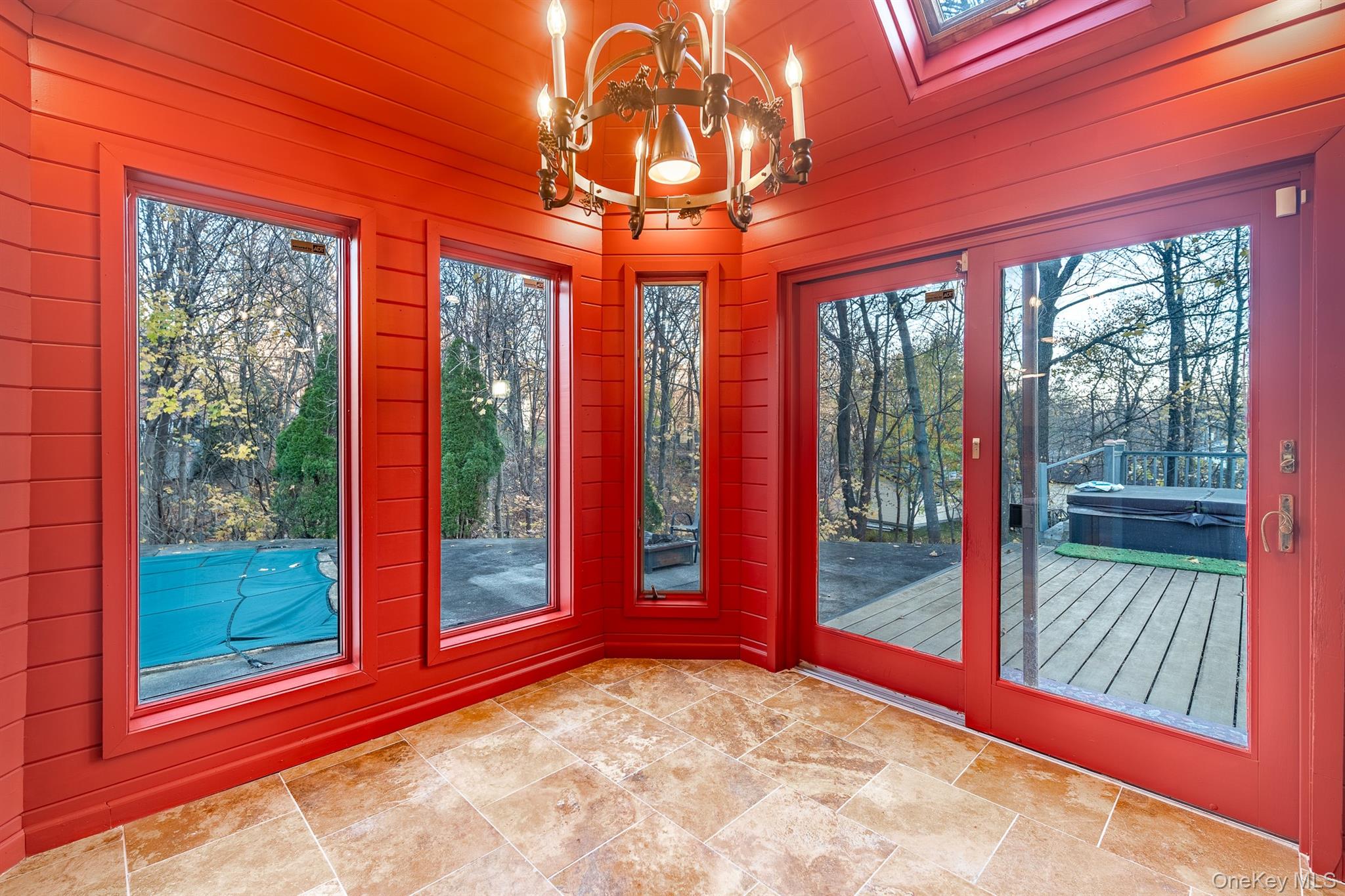 22 Weyant Road Fort Montgomery, NY 10922 - Photo 17 of 26 Unfurnished sunroom with plenty of natural light, a chandelier, wooden walls, and a skylight