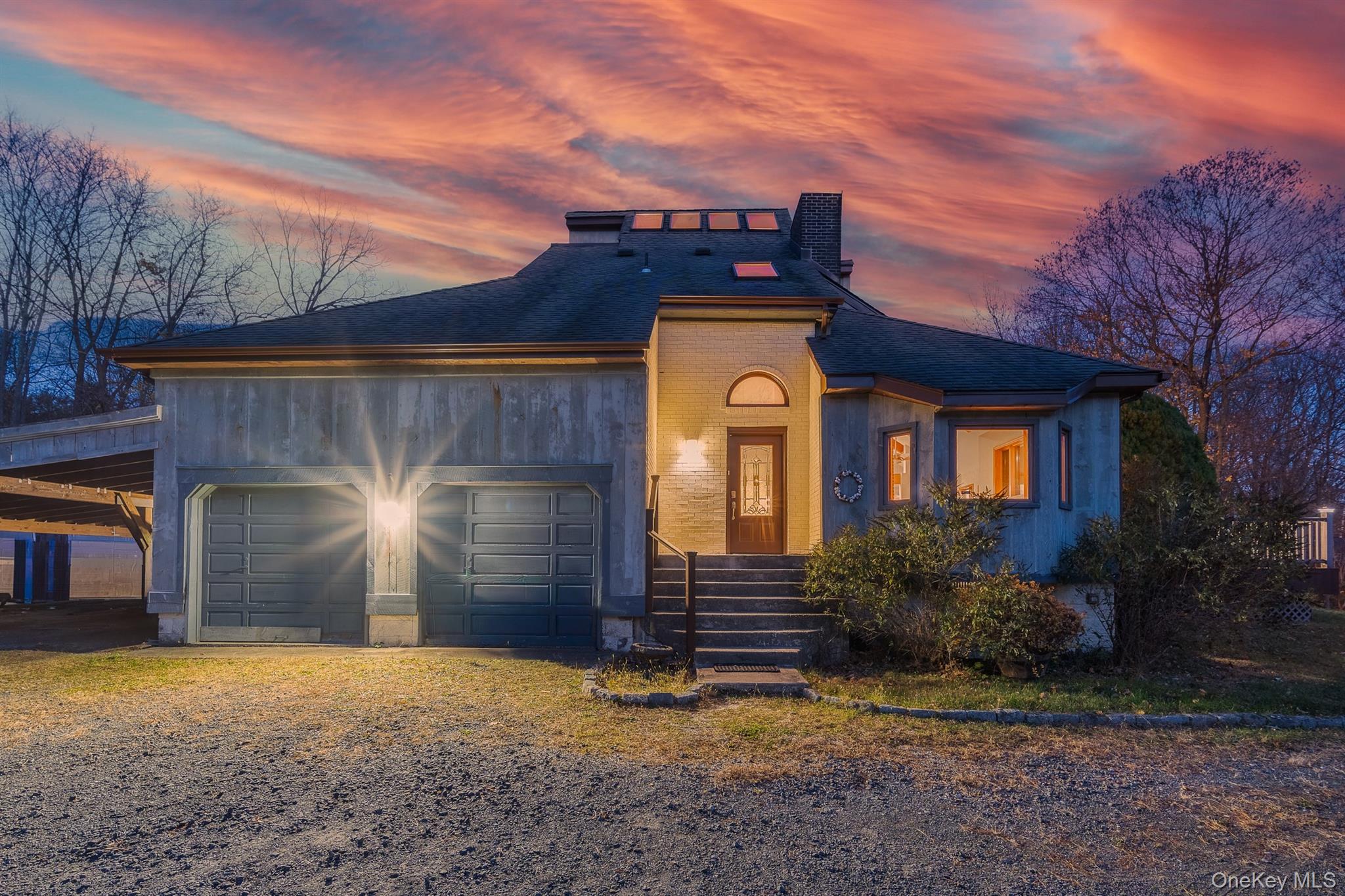 22 Weyant Road Fort Montgomery, NY 10922 - Photo 3 of 26 View of front of home with roof with shingles, brick siding, an attached garage, and a chimney