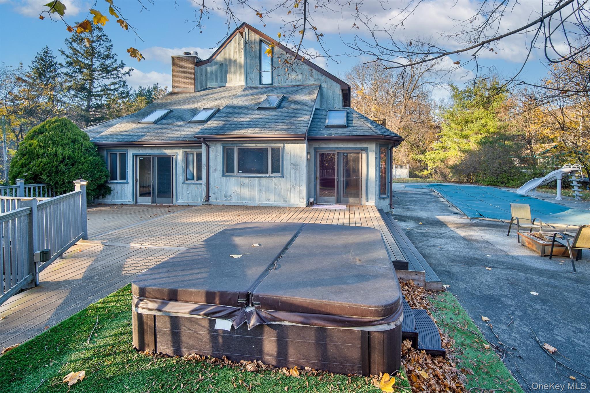 22 Weyant Road Fort Montgomery, NY 10922 - Photo 5 of 26 Back of house featuring a deck and a hot tub