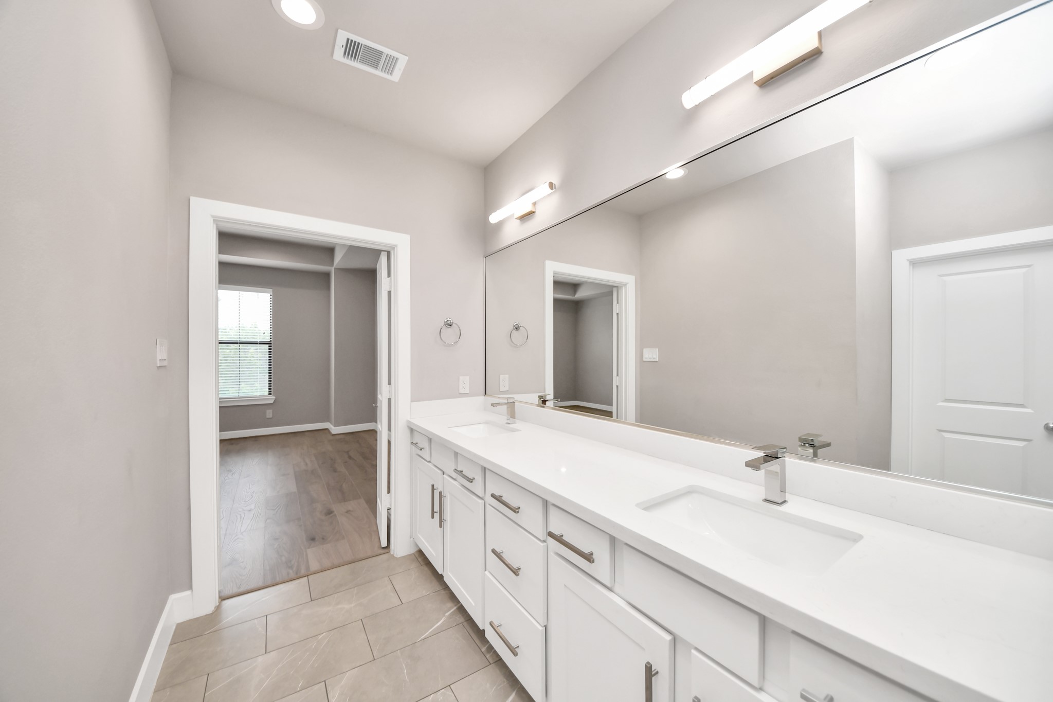 2114 Stuart Street Houston, TX 77004 - Photo 34 of 39 a spacious bathroom with a double vanity sink and mirror