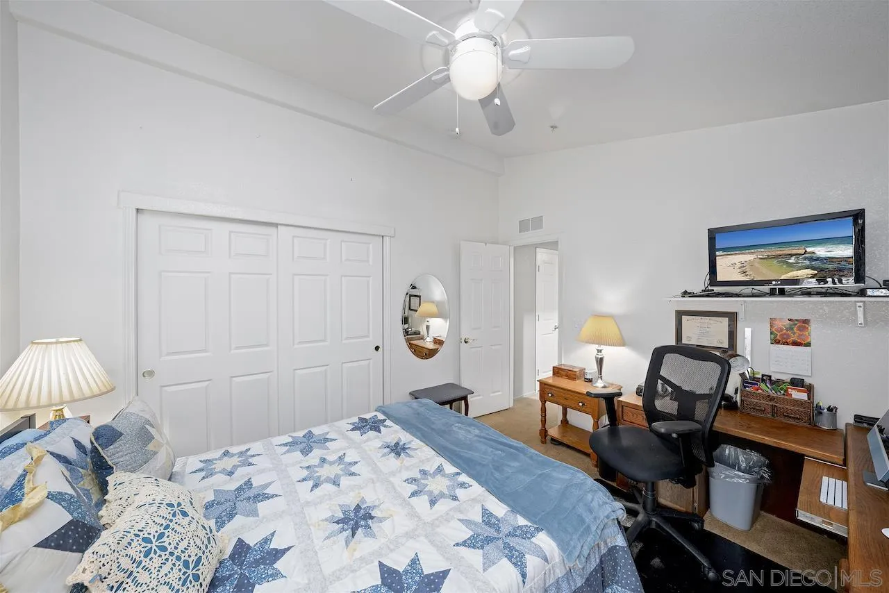 21851 Japatul Road Alpine, CA 91901 - Photo 35 of 52 a bedroom with a bed and a chandelier