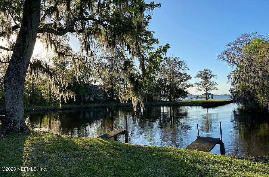 12834 Mandarin Road Jacksonville, FL 32223 - Photo 2 of 51 a view of a lake with a garden