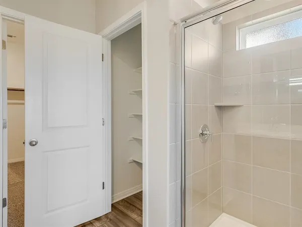 a bathroom with a glass shower door