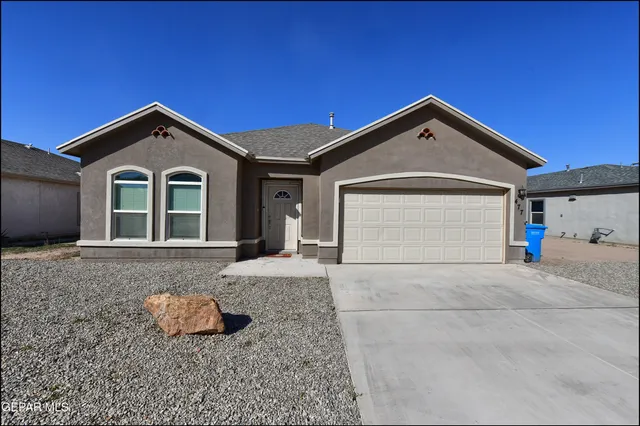 a view of a house with a yard and garage