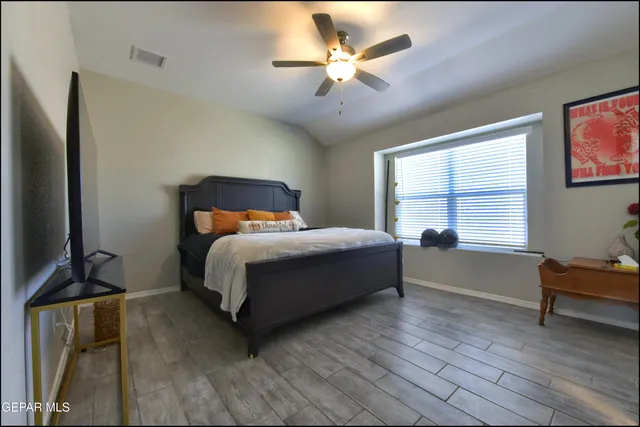 a bedroom with a bed and a window