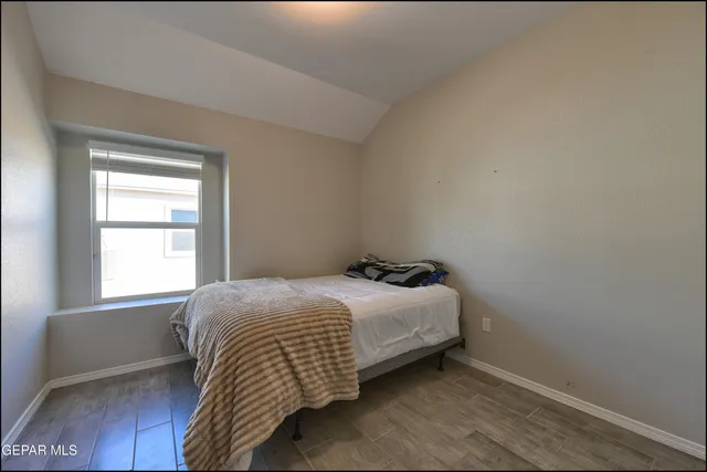 a bedroom with a bed and window
