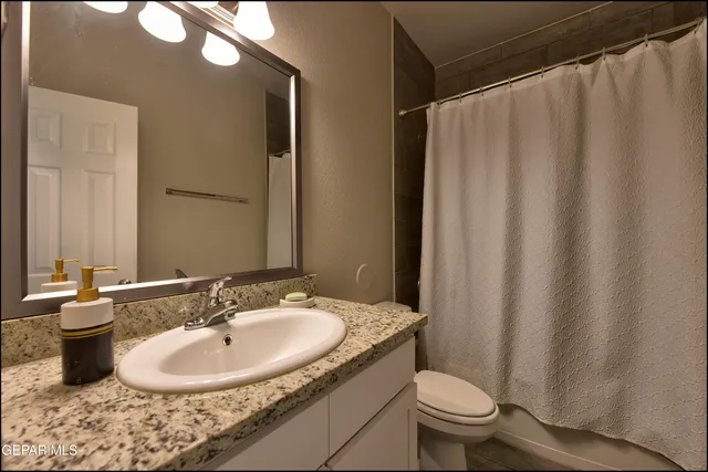 a bathroom with a sink toilet and a mirror