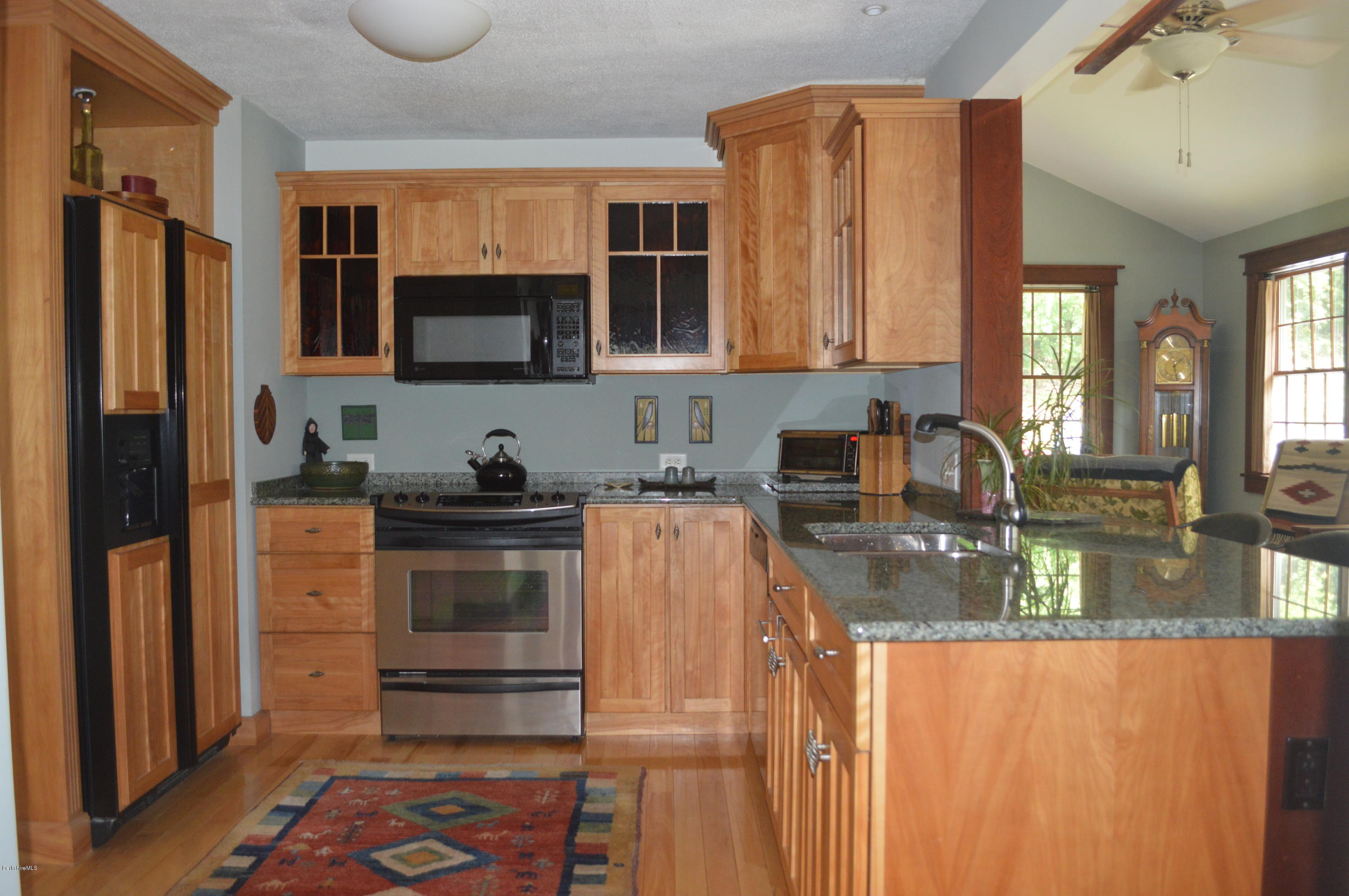 150 Maple Street Lee, MA 01238 - Photo 15 of 57 a kitchen with stainless steel appliances granite countertop a refrigerator stove and sink