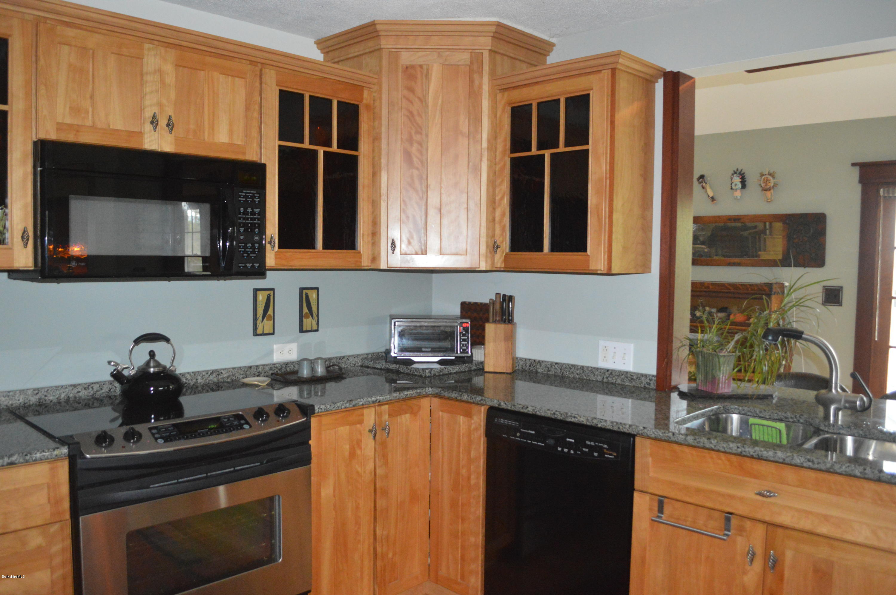 150 Maple Street Lee, MA 01238 - Photo 16 of 57 a kitchen with stainless steel appliances granite countertop a stove a sink and a microwave