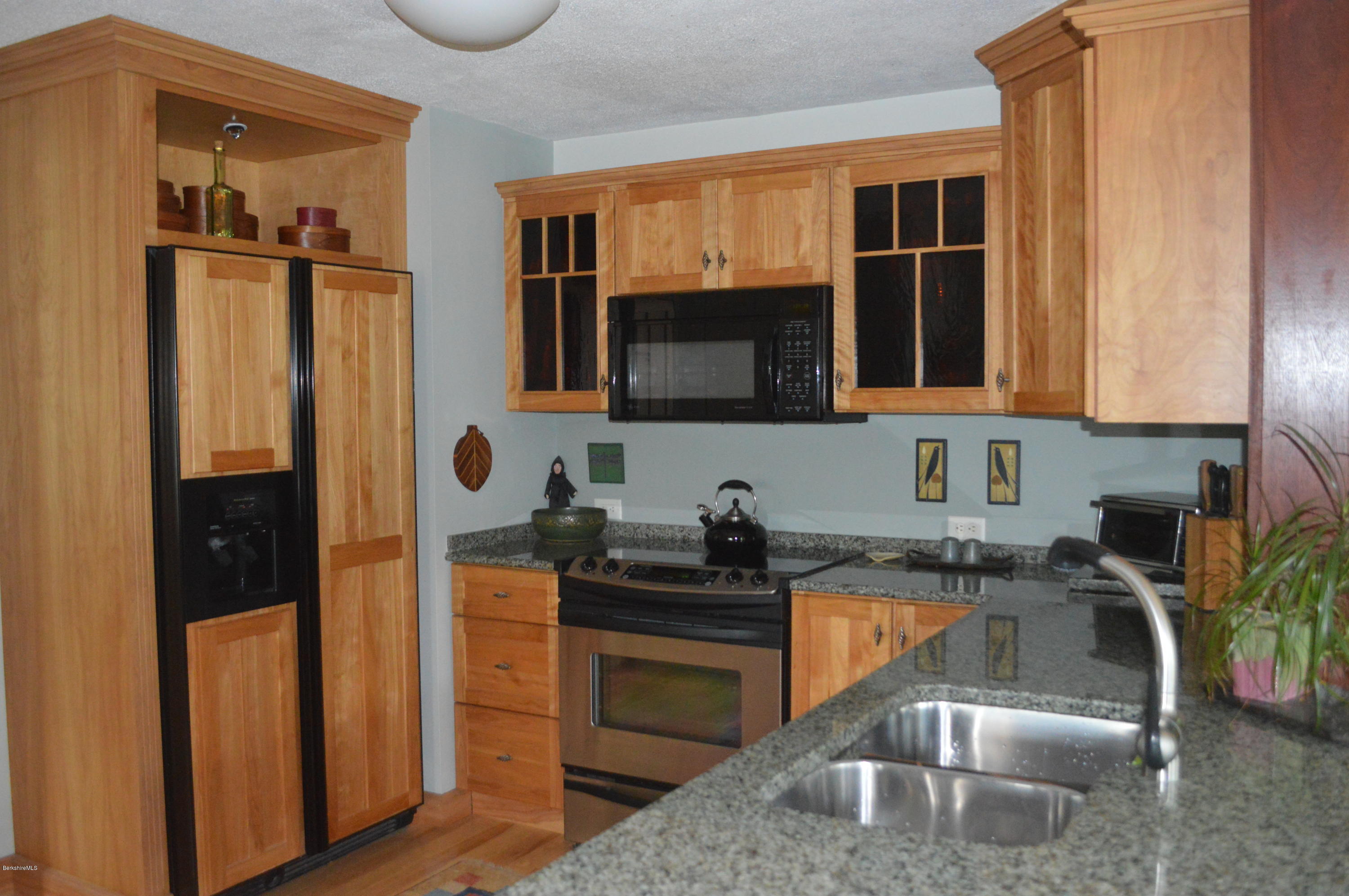 150 Maple Street Lee, MA 01238 - Photo 17 of 57 a kitchen with a sink stove and refrigerator