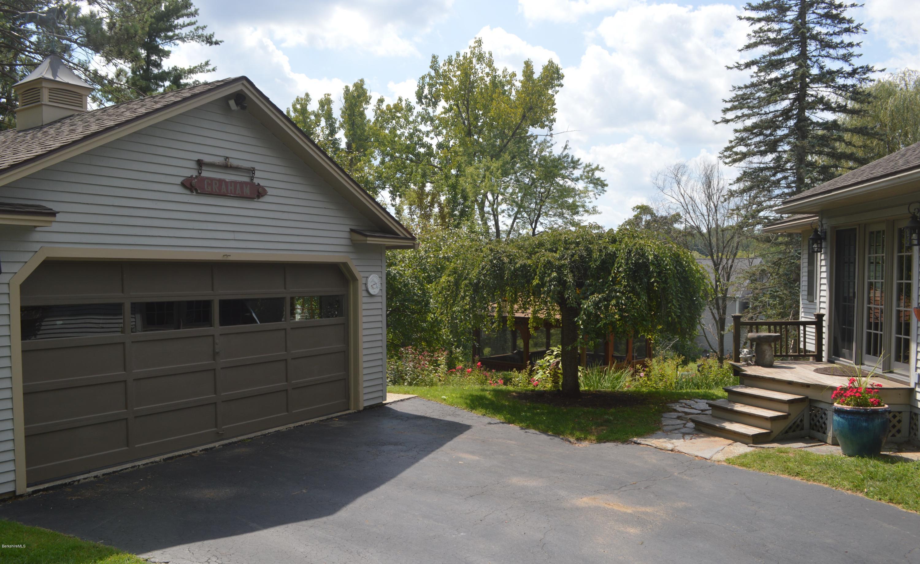 150 Maple Street Lee, MA 01238 - Photo 3 of 57 a front view of a house with a yard and garage