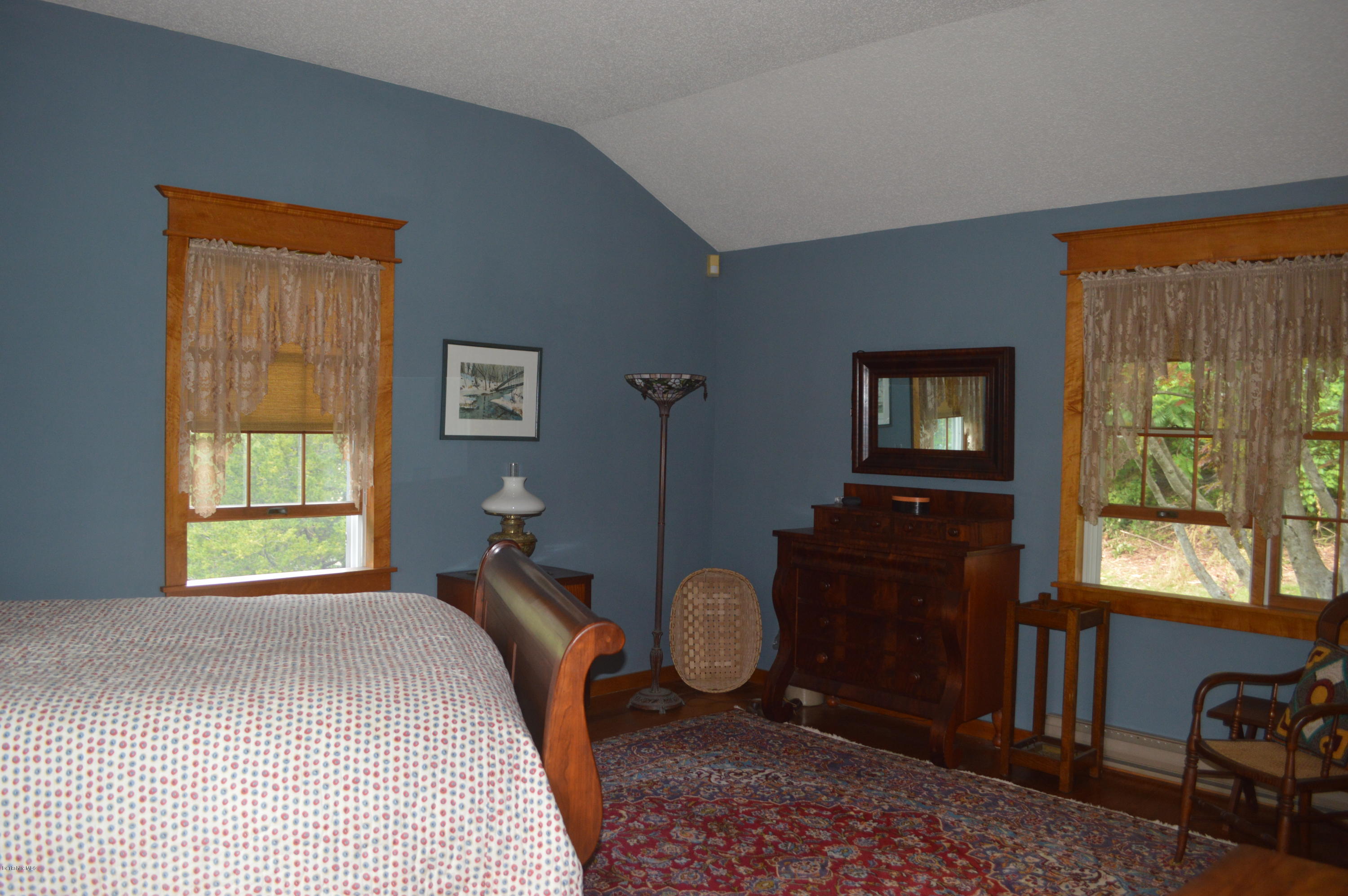 150 Maple Street Lee, MA 01238 - Photo 23 of 57 a bedroom with a bed and wooden floor