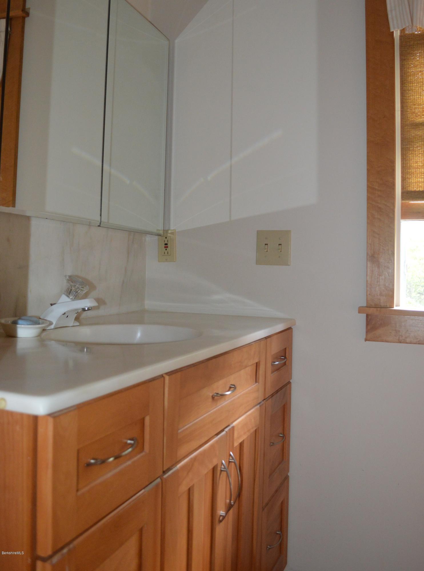 150 Maple Street Lee, MA 01238 - Photo 24 of 57 a kitchen with a sink cabinets and window